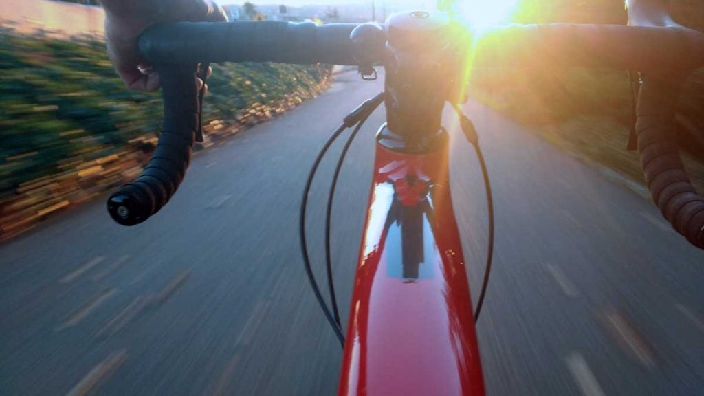 biking at sunrise or sunset from handlebars