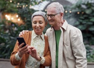 Two seniors looking at mobile phone together